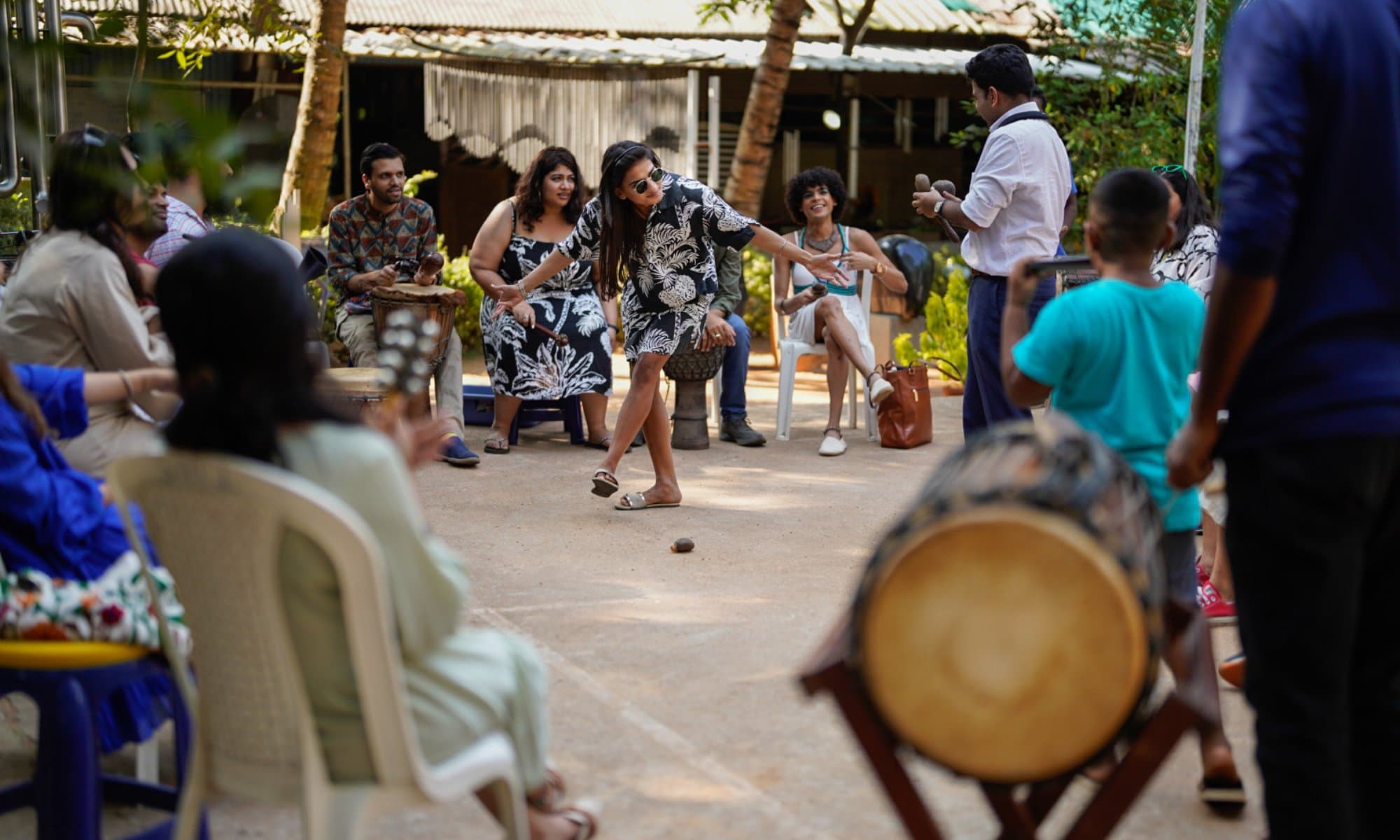 A drum circle and dancing in a garden at an ExCo gathering