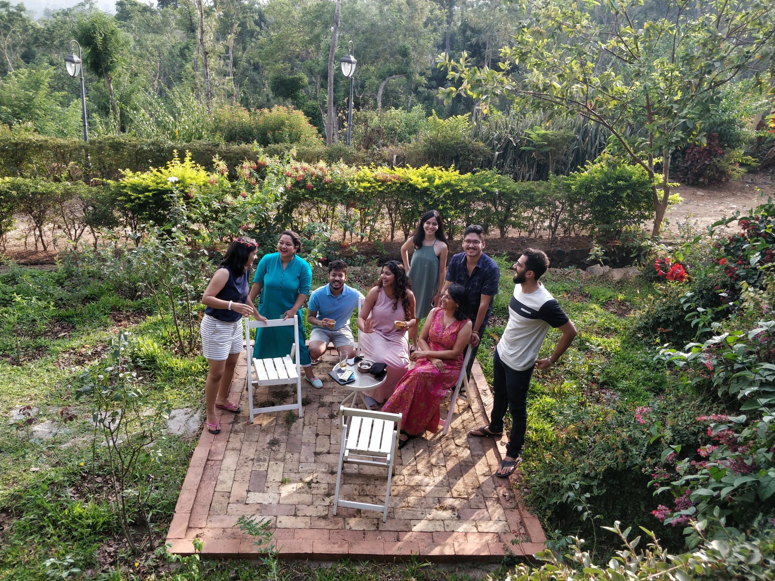 A Story Collective group talking in a garden