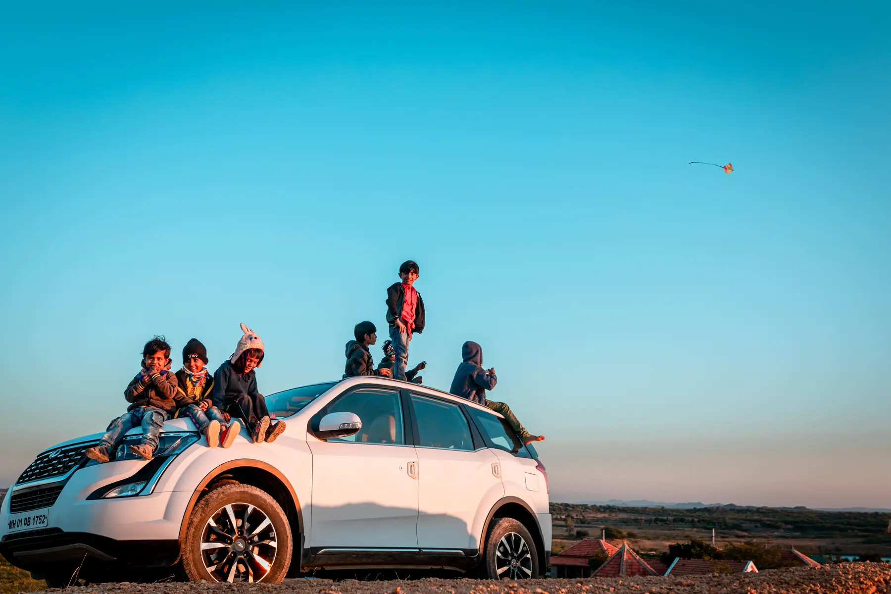 ExCo travelers riding on a car at sunset