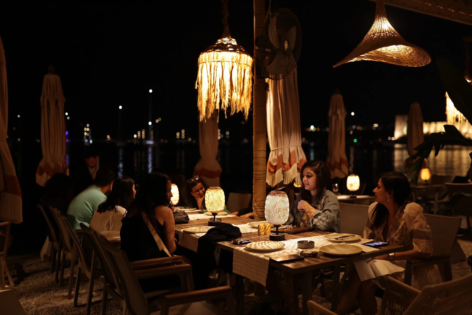 Four group dinners across the trip: welcome mezze in Göreme, a kebab night under stone walls, a dressed-up Bodrum tribe dinner, and the farewell on the water