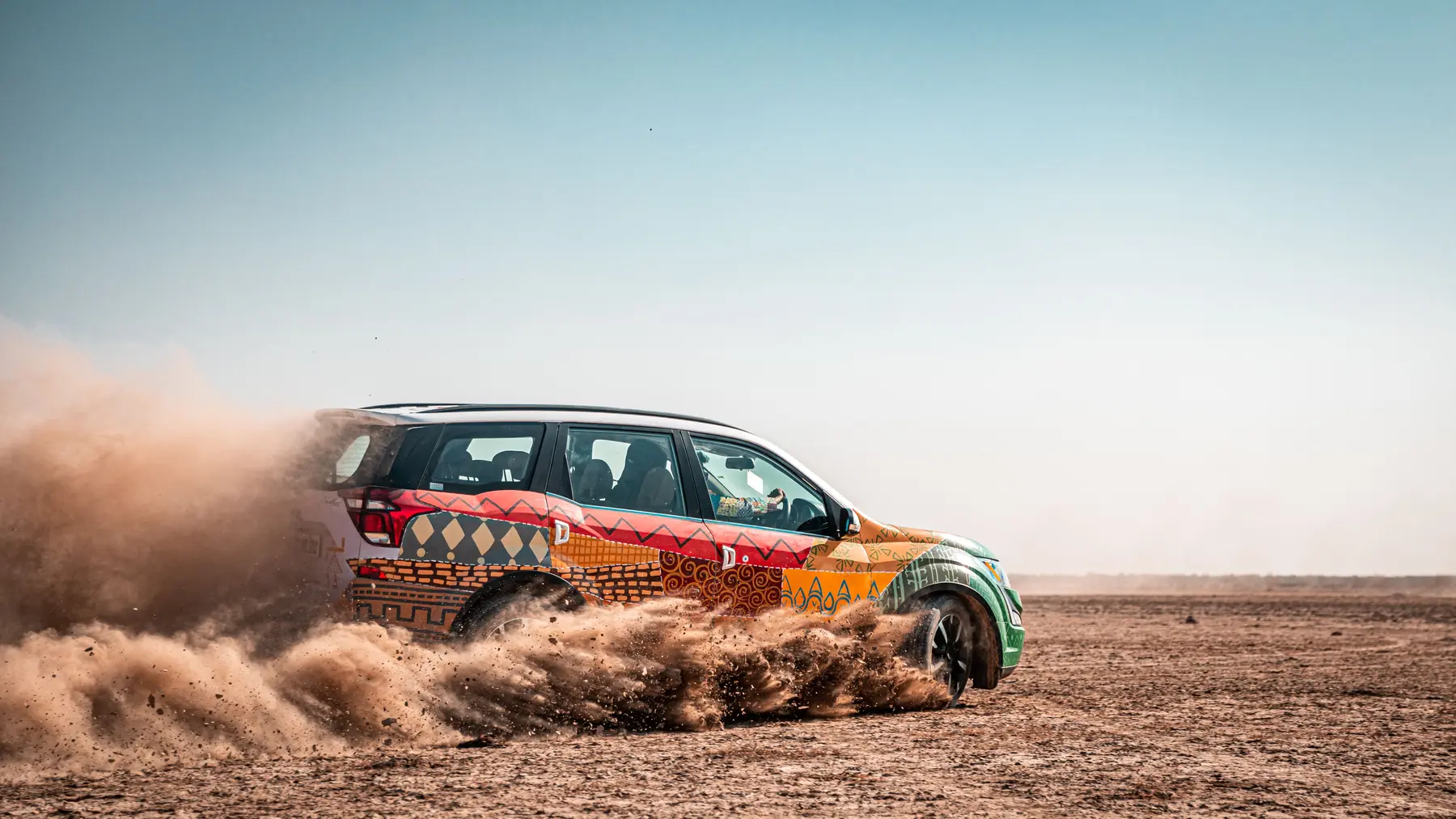 ExCo roadtrip car kicking up sand